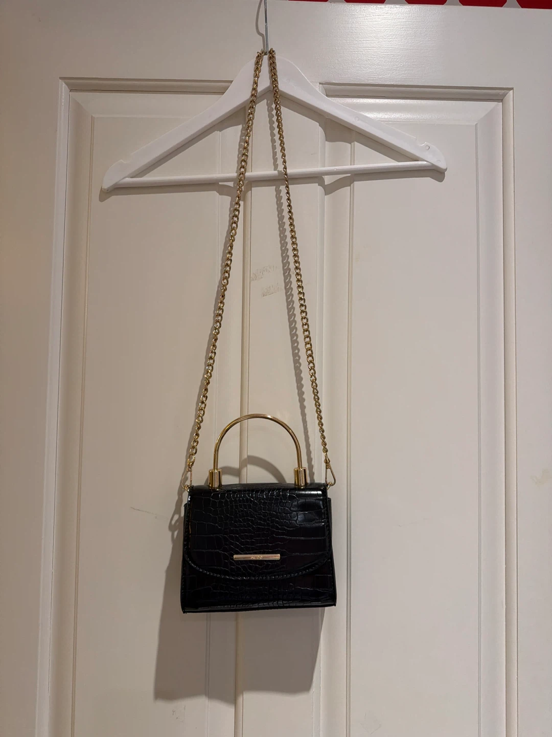 Small black ALDO purse with gold chain