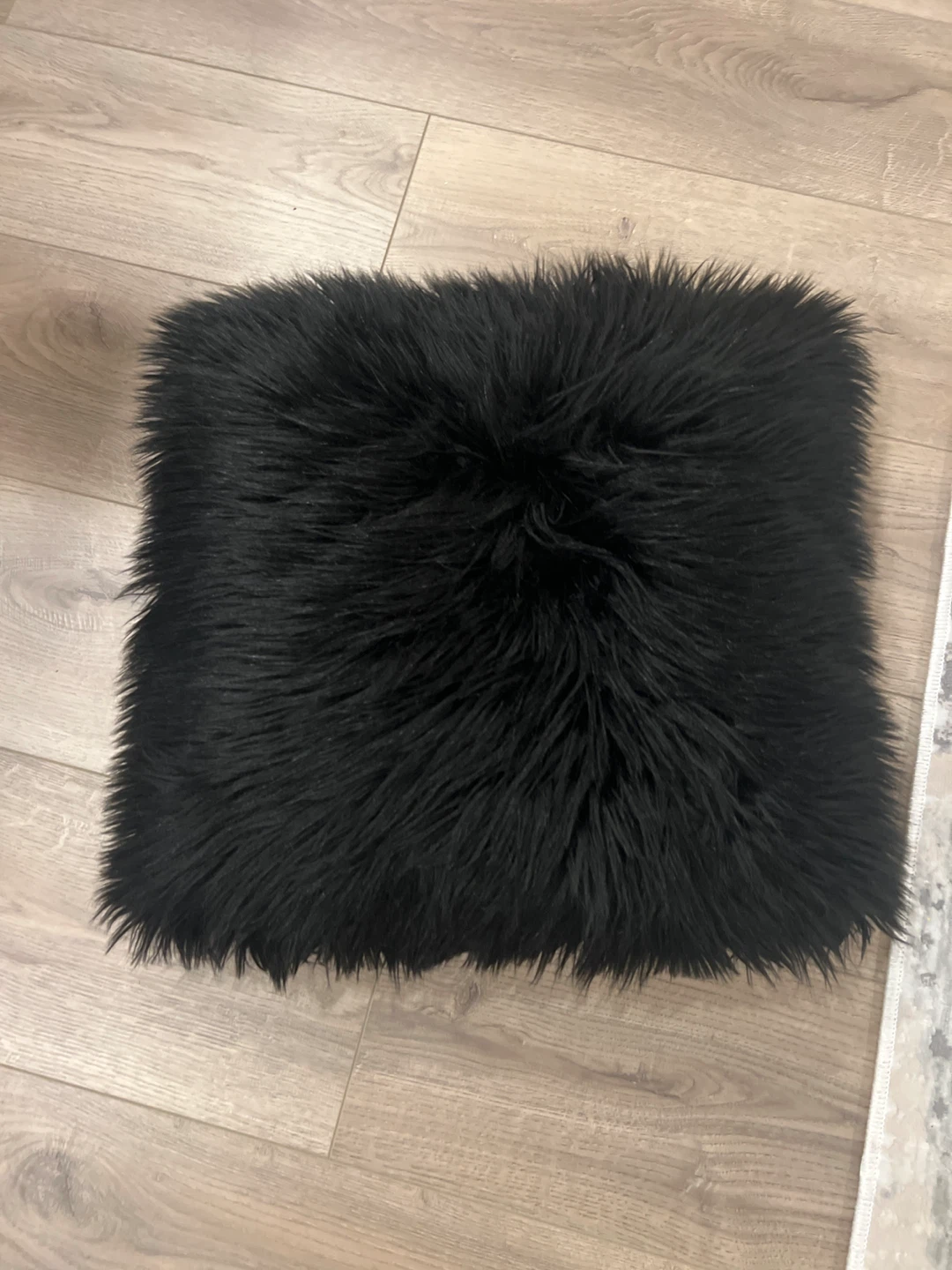Black faux fur cushion