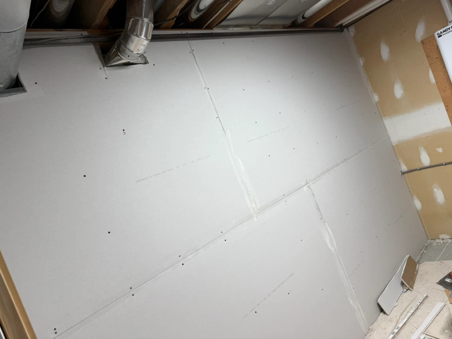 Unfinished Basement Wall with Drywall and Framing - photo 2