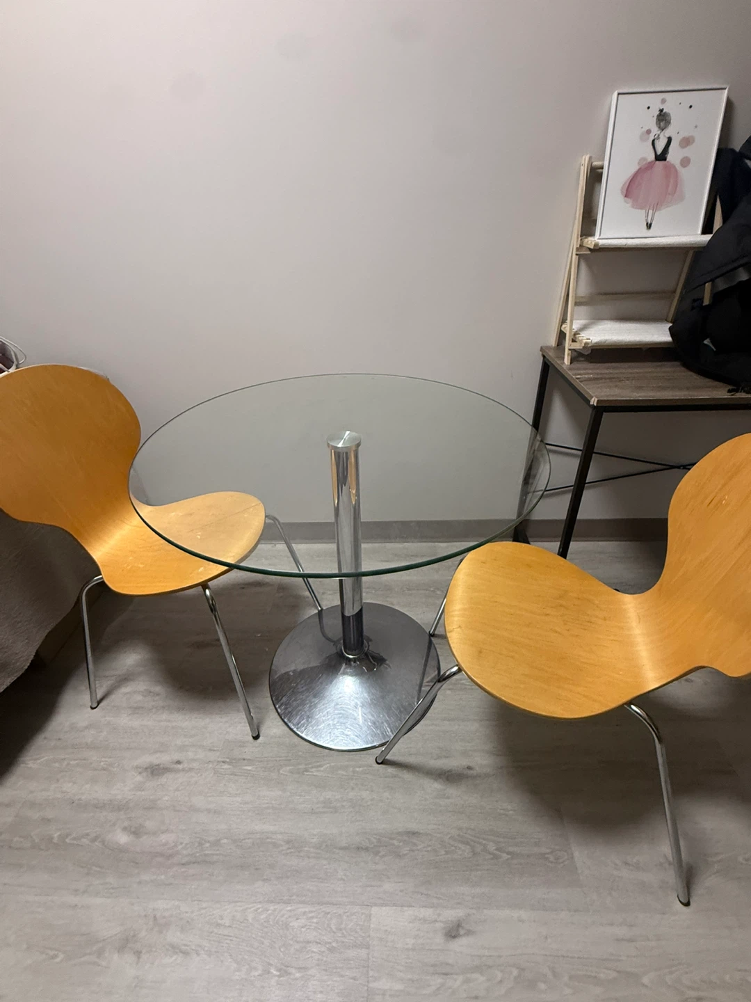 Glass top bistro table with two wooden chairs