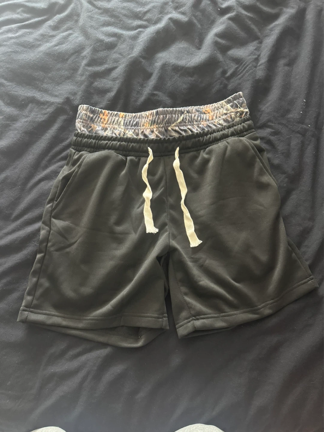 Black athletic shorts with camouflage waistband