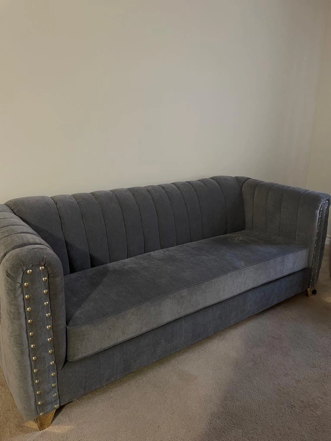 Grey tufted sofa