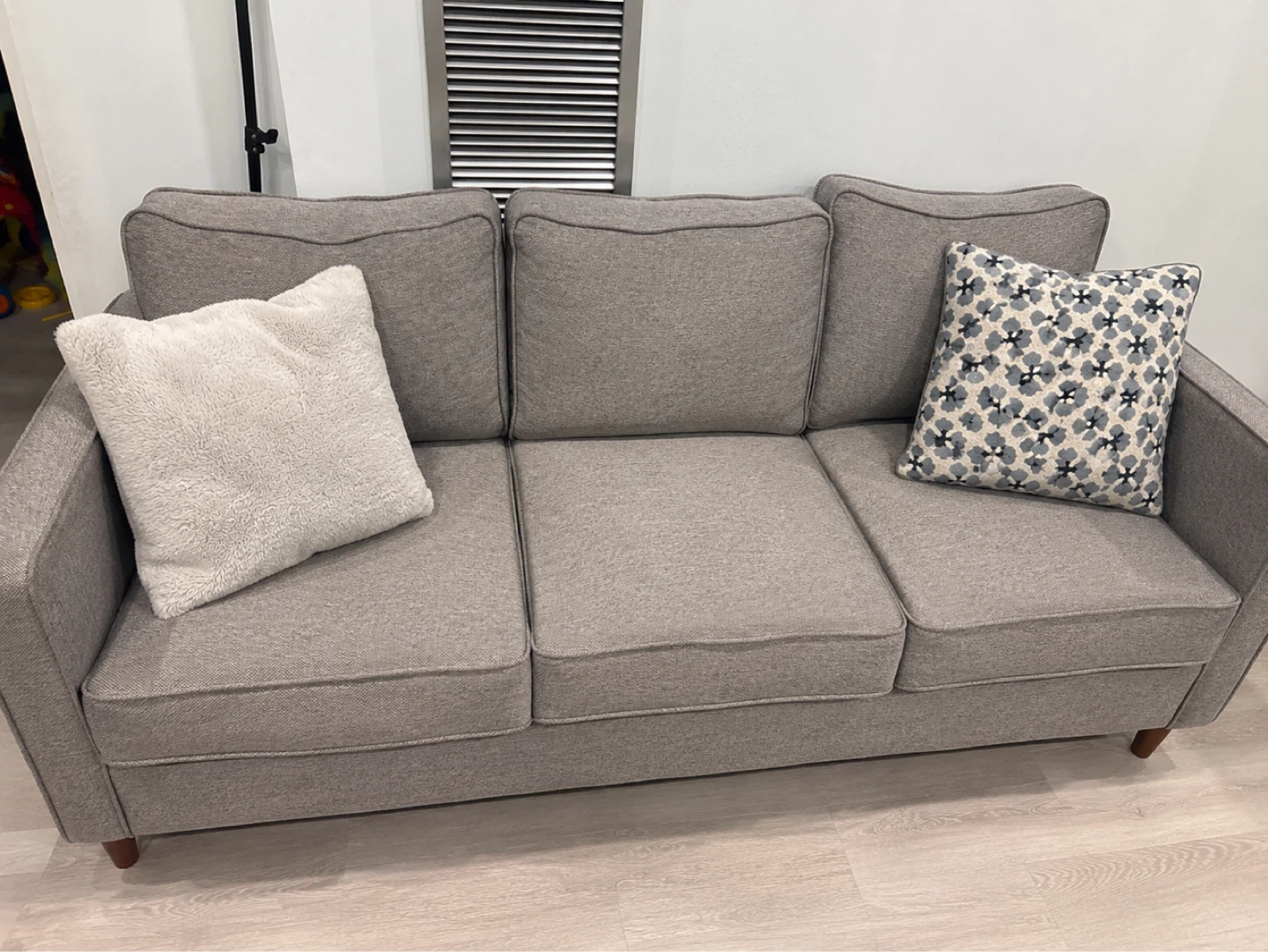 Grey Three-Seater Sofa with Decorative Pillows
