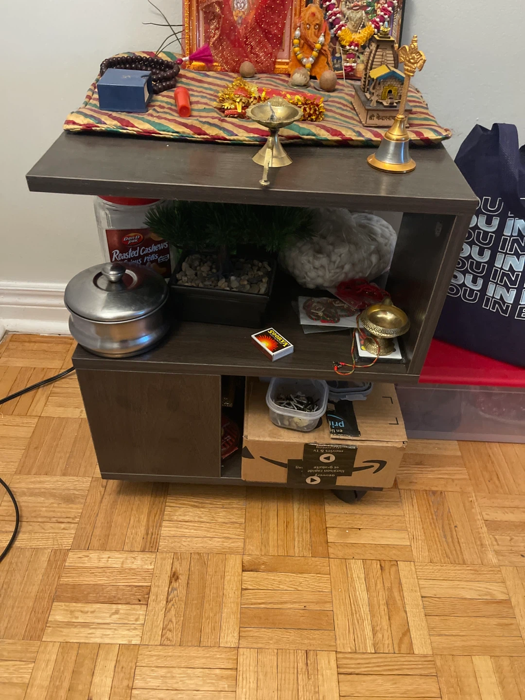 Small dark brown rolling accent table