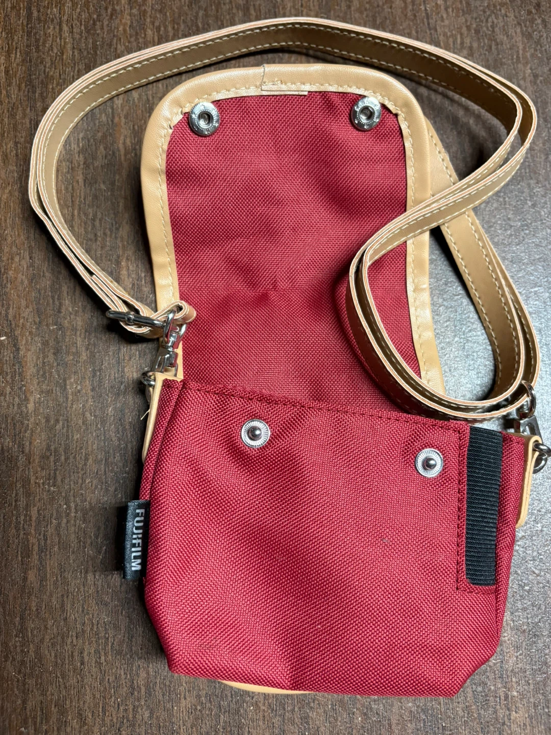 A NEW FUJIFILM Red Small Crossbody Bag with a little toy