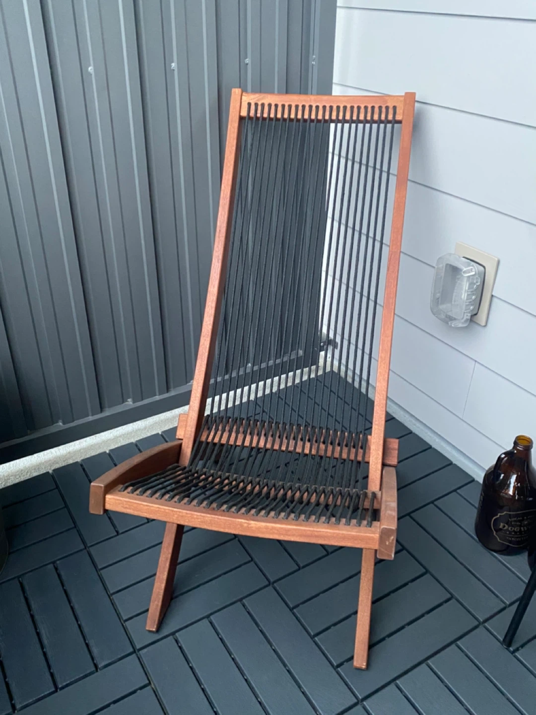 Wooden lounge chair with black cord seating