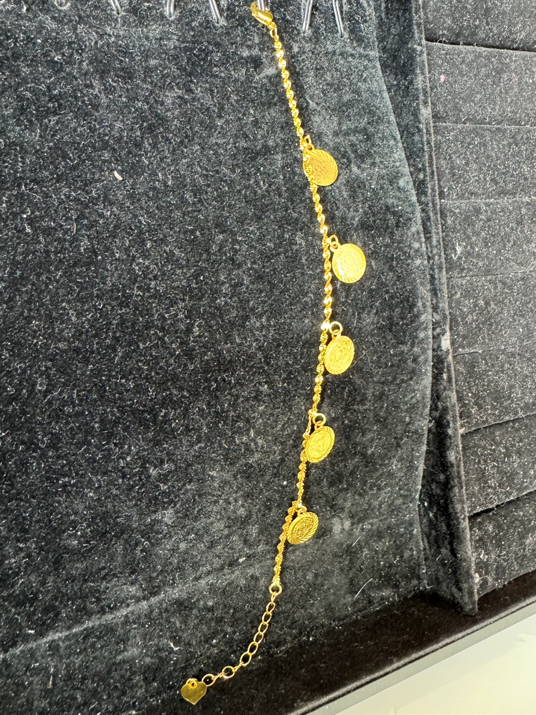 Gold tone bracelet with coin charms