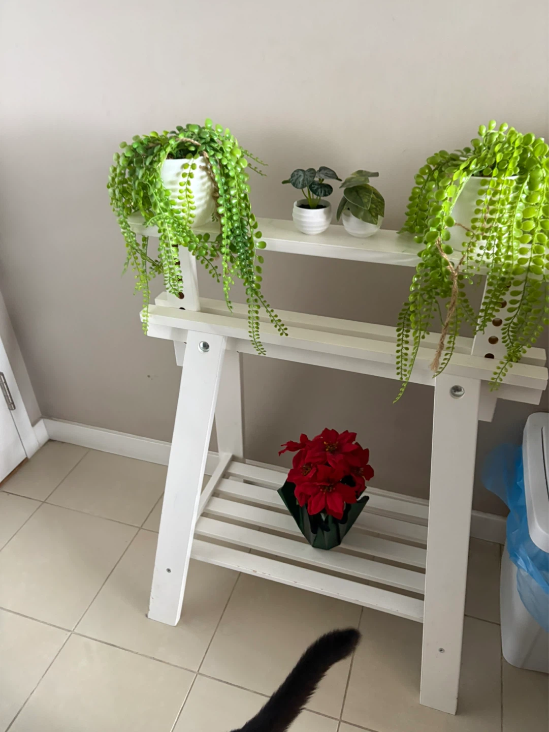 White wooden plant stand with artificial plants