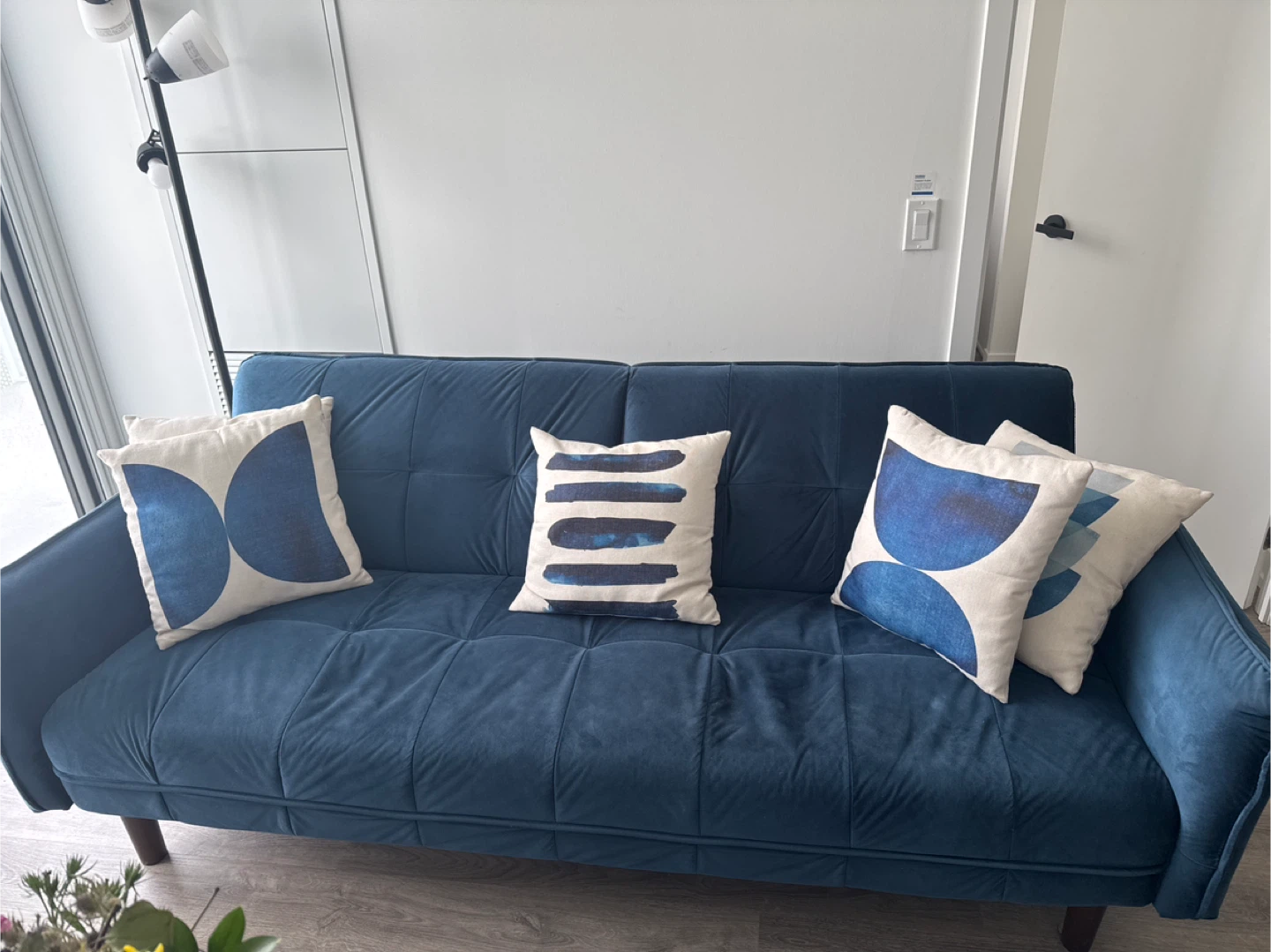 Deep Blue Tufted Sofa with Decorative Pillows