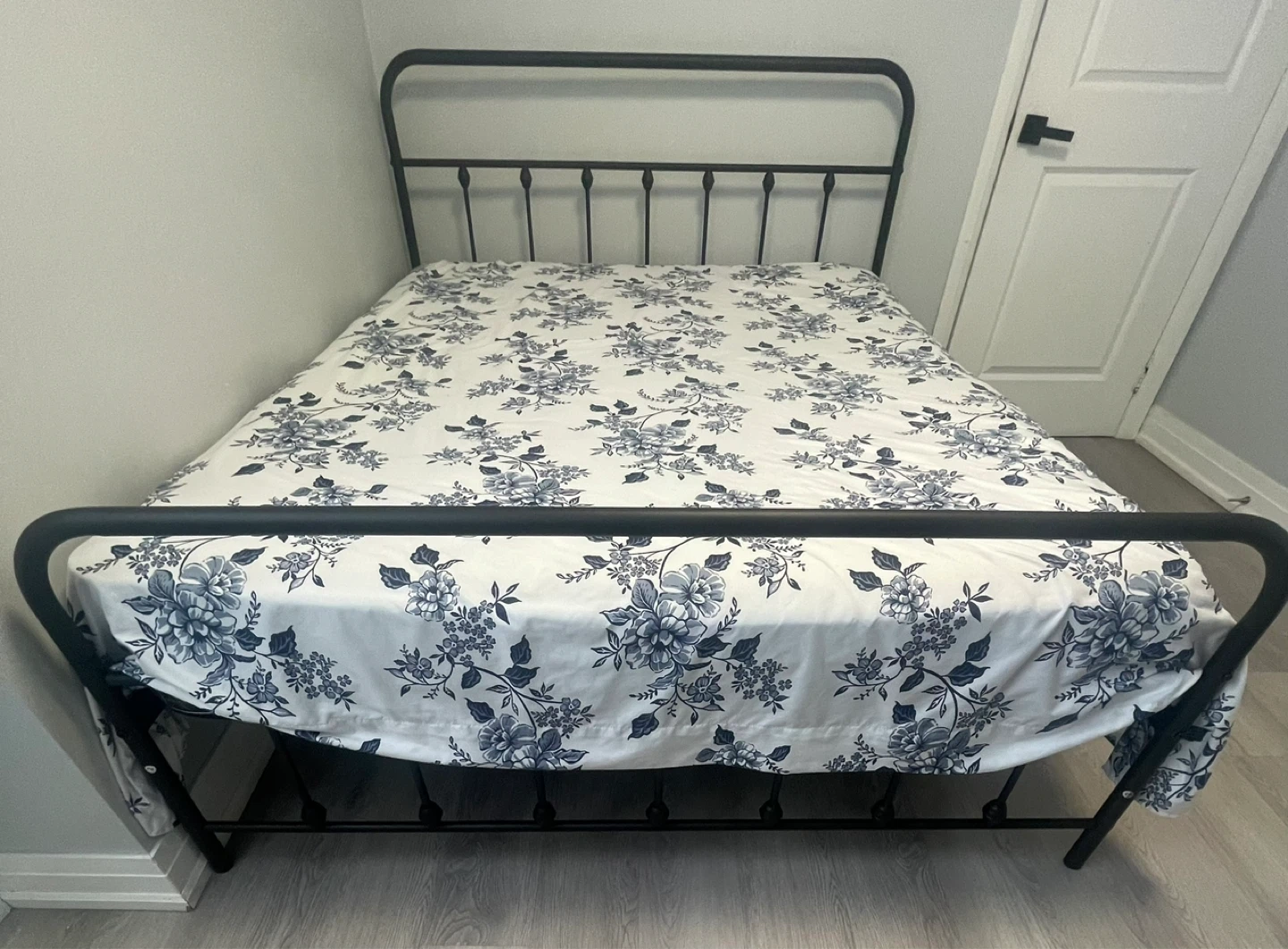 Black Metal Bed Frame with Floral Bedding