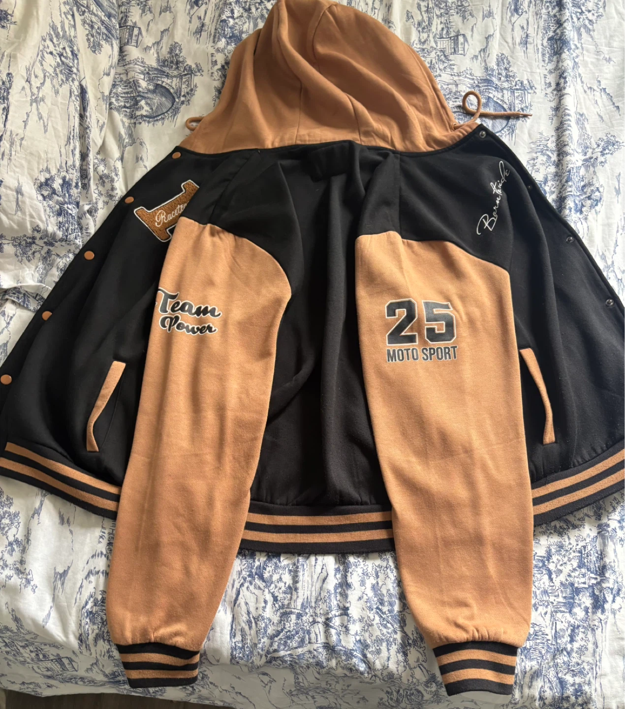 Black and tan/brown varsity-style bomber/letterman jacket
