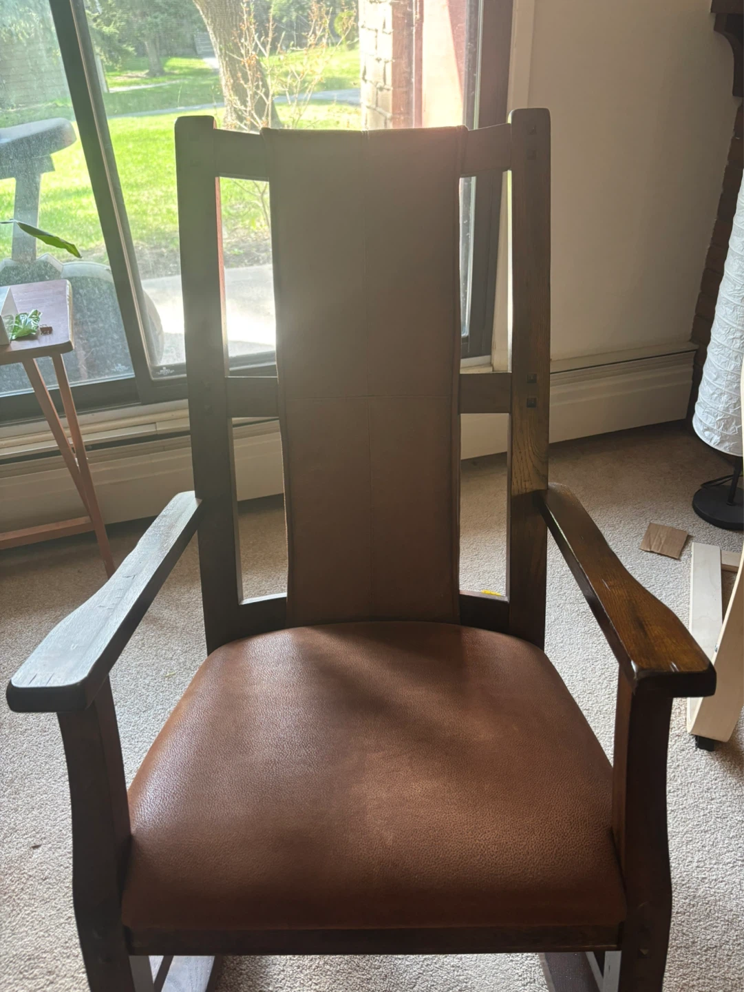 Wooden armchair with brown leather seat and back