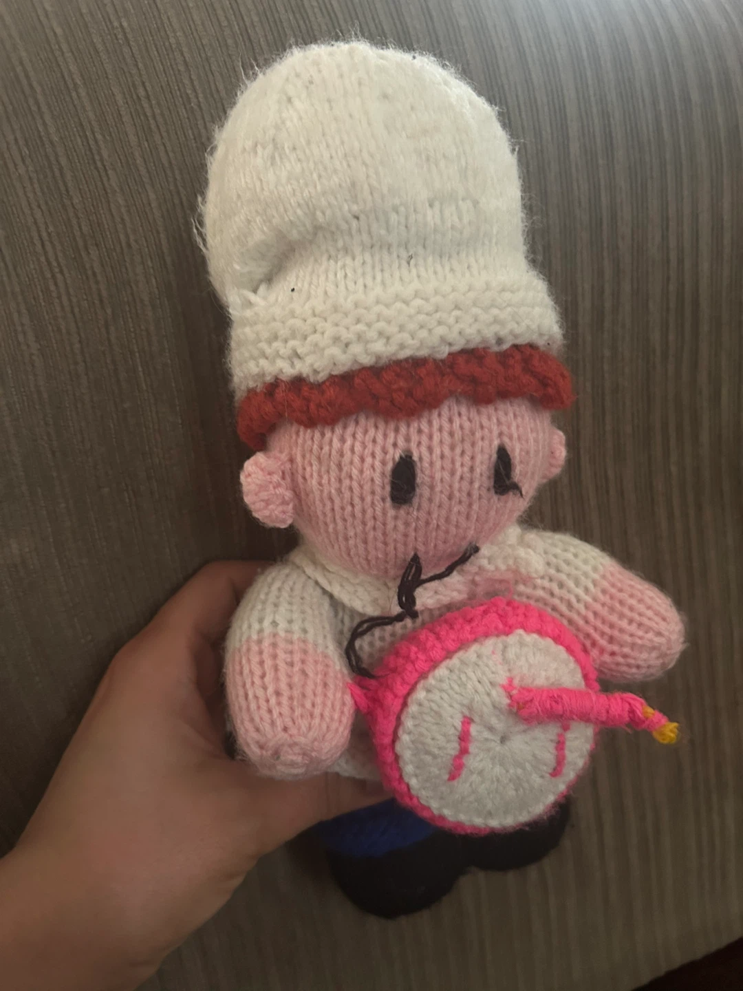 Hand-knitted toy figure with drum