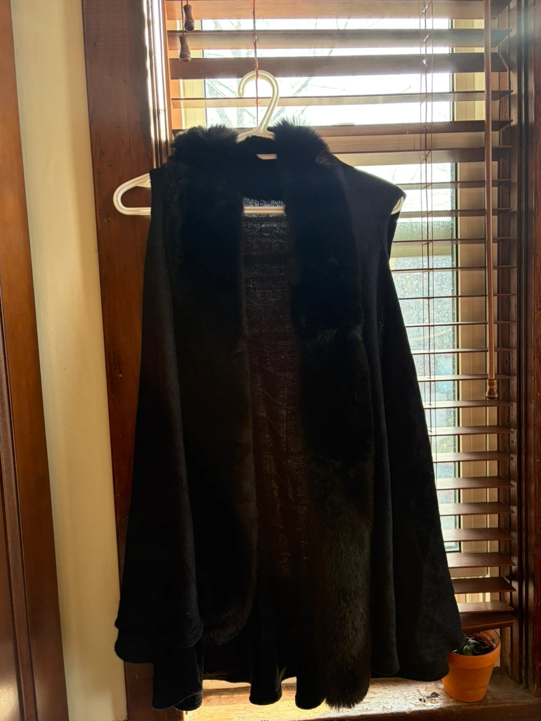 Black sleeveless vest with faux fur trim