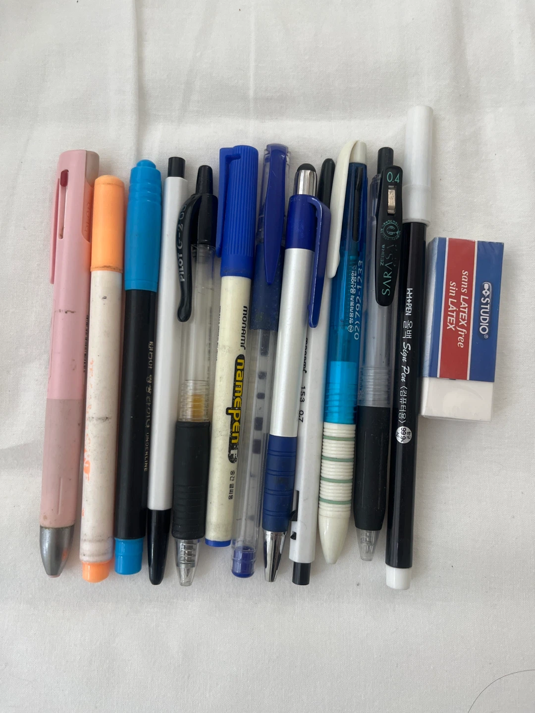 Assorted Pens, Markers, and Eraser