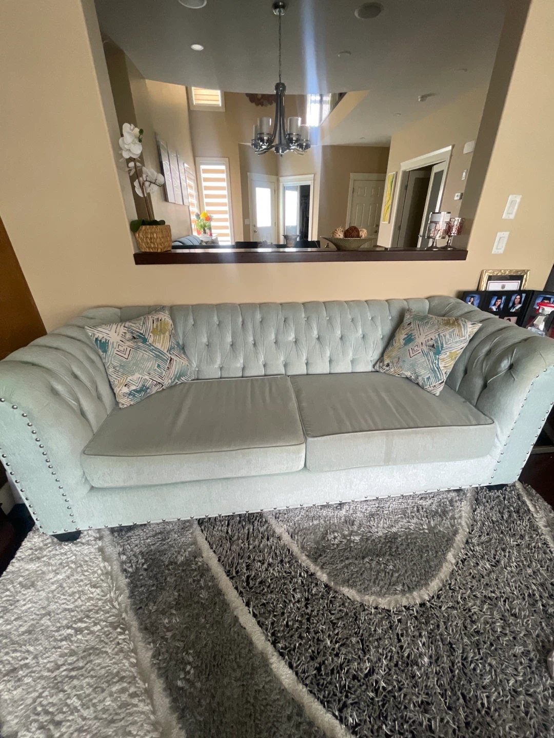 Light Blue Tufted Sofa with Decorative Pillows