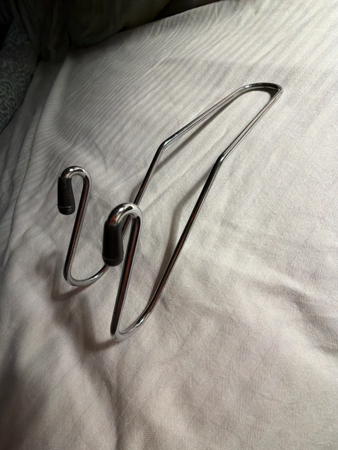 Metal hook for bags behind car front seat