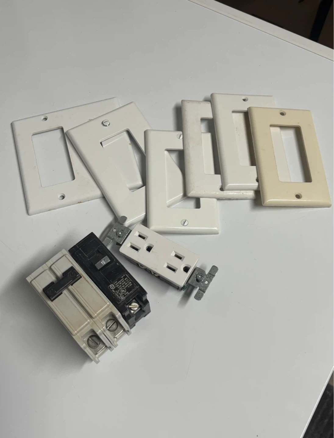 Assorted Electrical Outlet Covers, Breakers, and Outlet