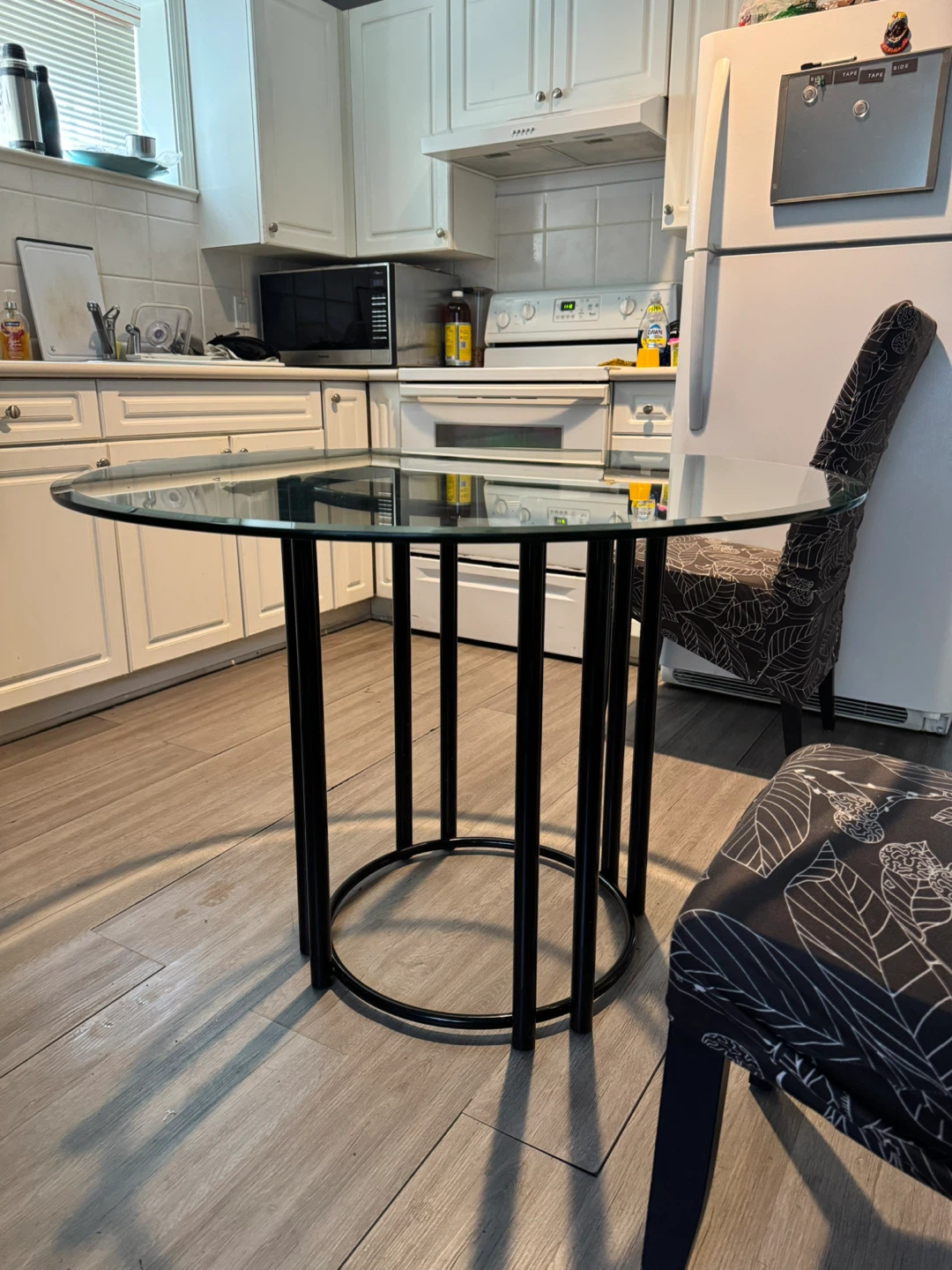 Round Glass Top Dining Table with Black Metal Base