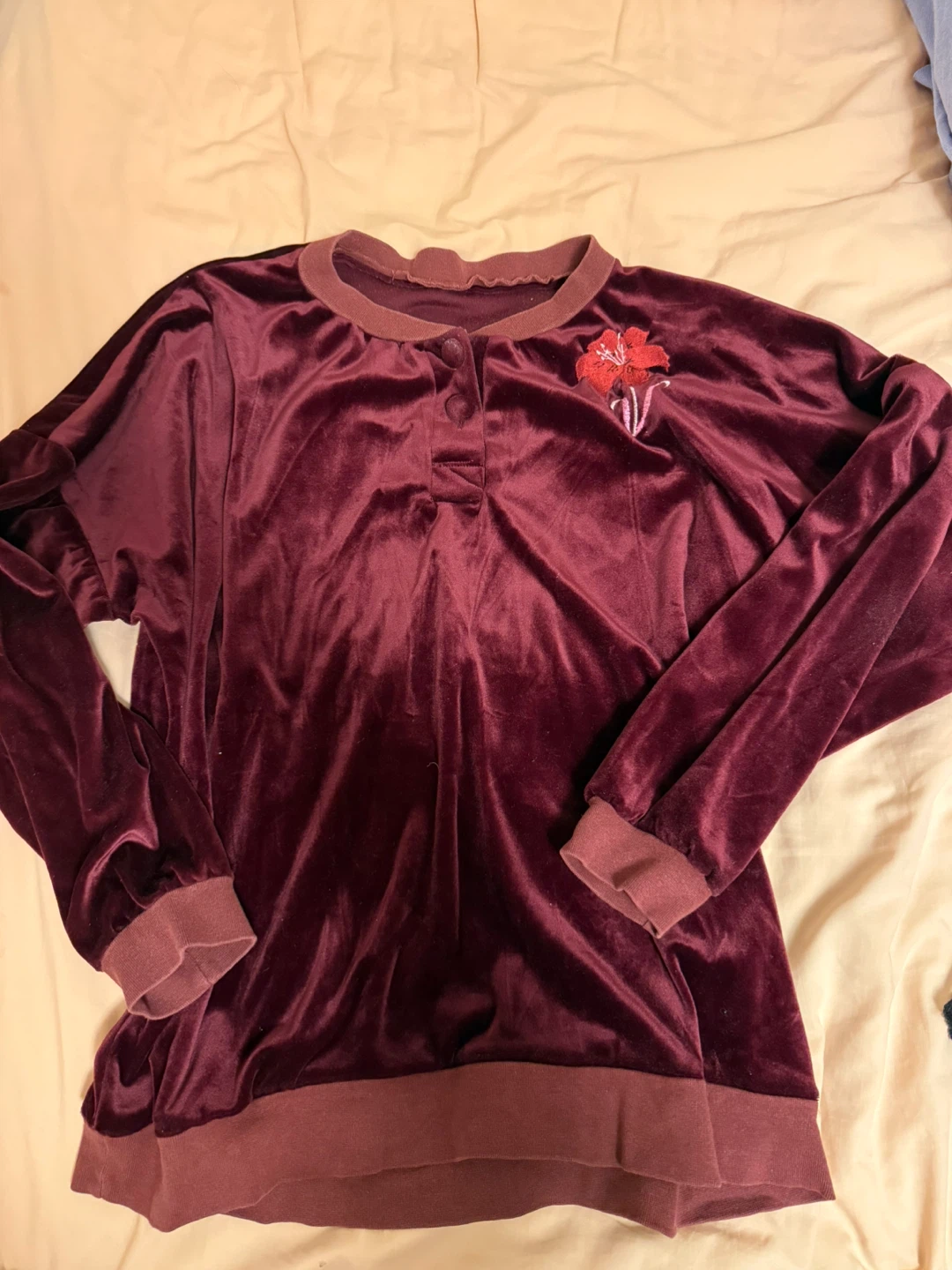 Red / maroon velvet top with a flower decoration