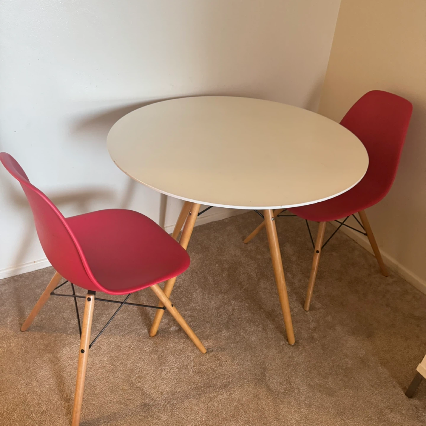 Round White Dining Table with 2 Red Chairs
