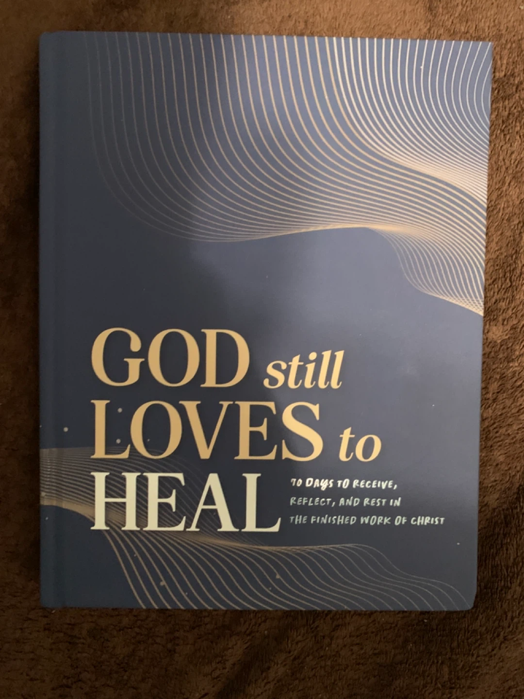 God Still Loves To Heal (2026) Hardcover