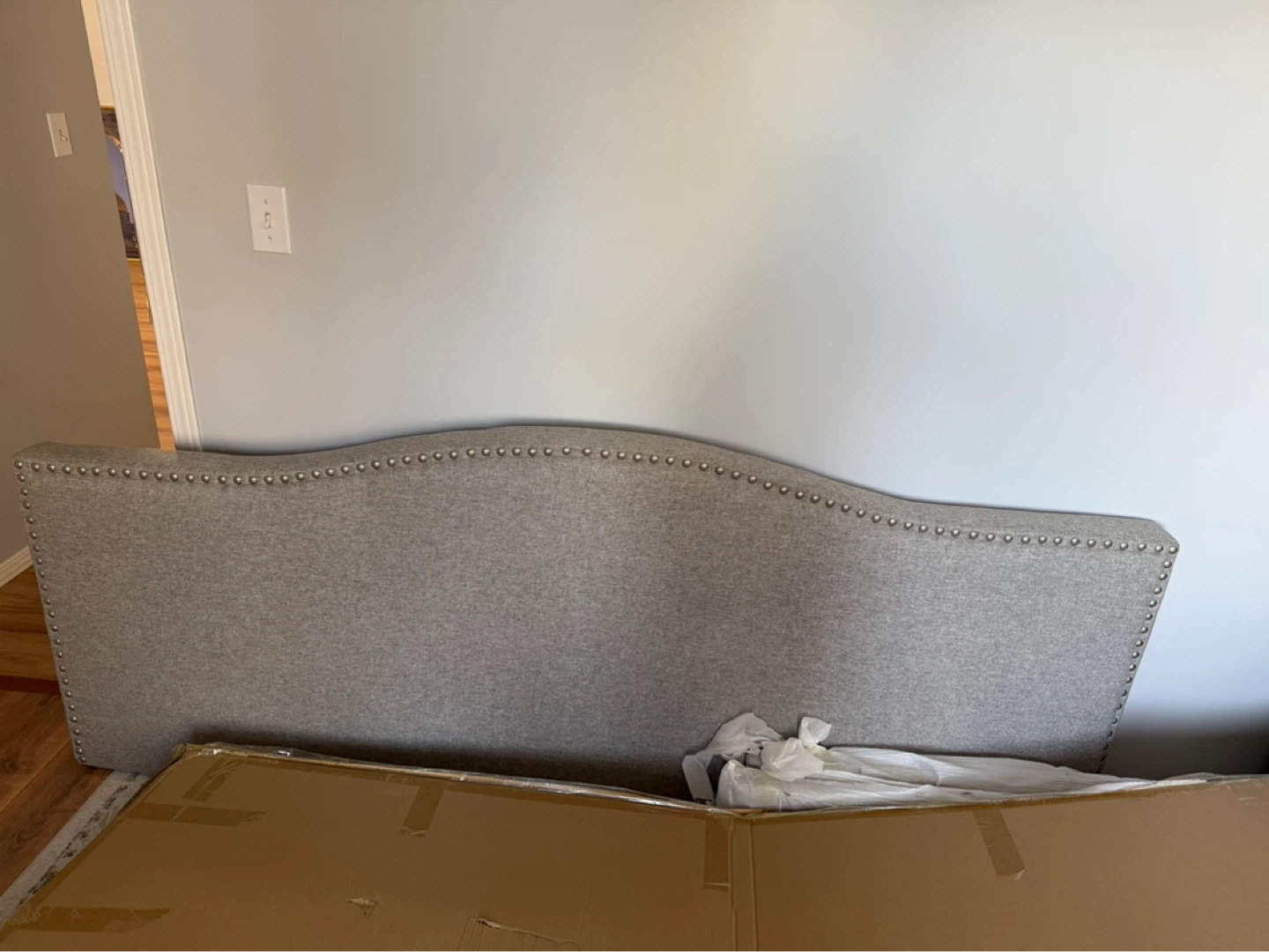 Grey Upholstered Headboard with Silver Nailhead Trim