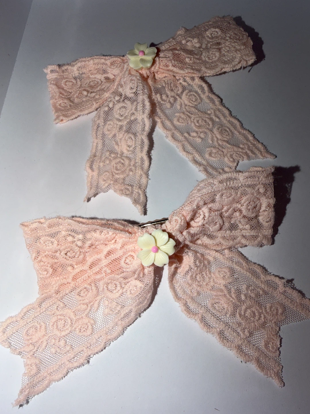 Two pink lace hair bows with flower accent