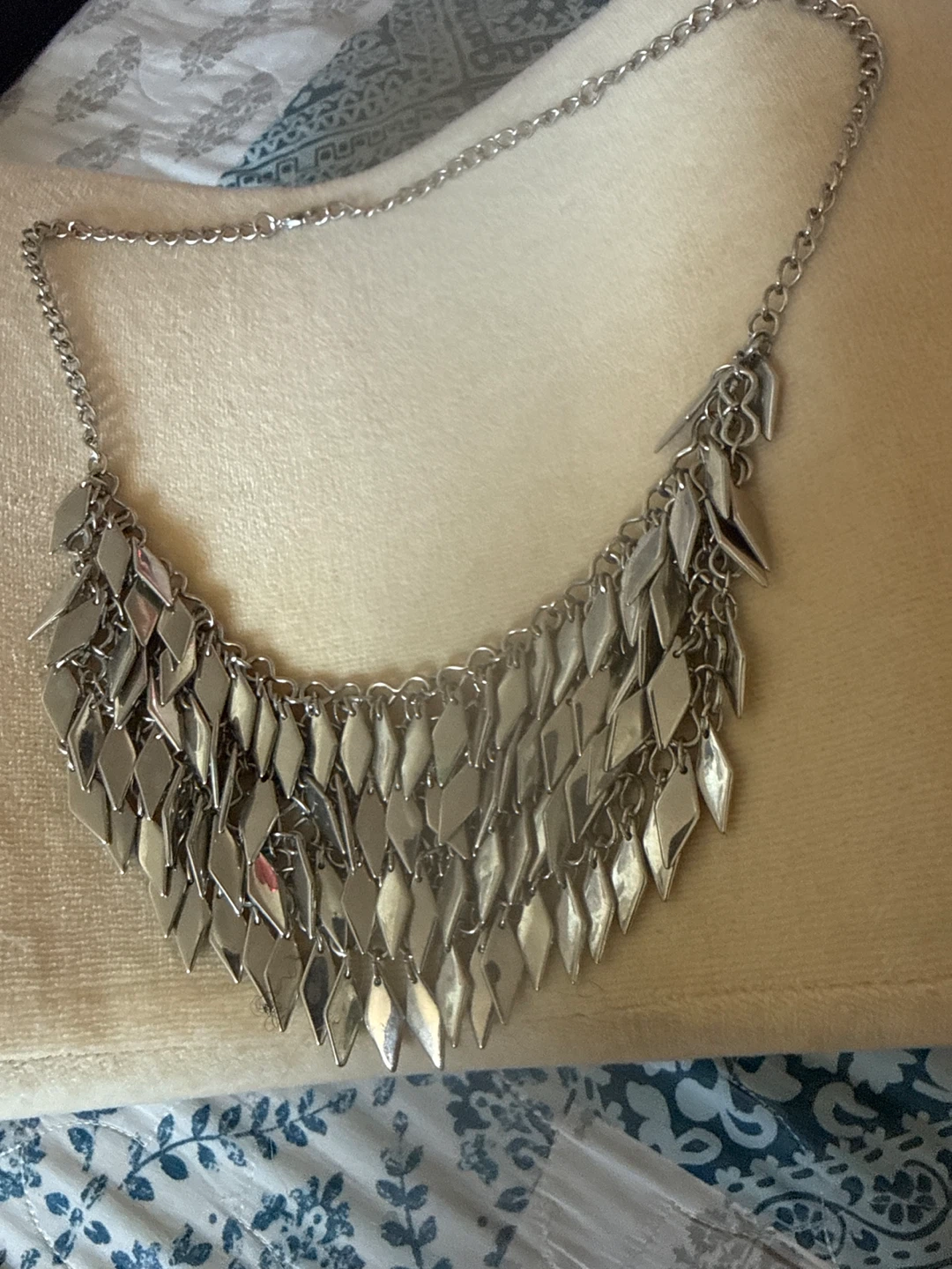 Silver tone statement necklace with diamond shaped charms