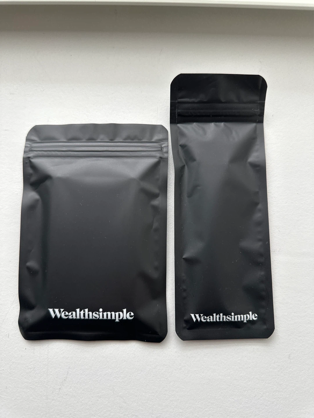 Wealthsimple wallet, keychain, socks, bag