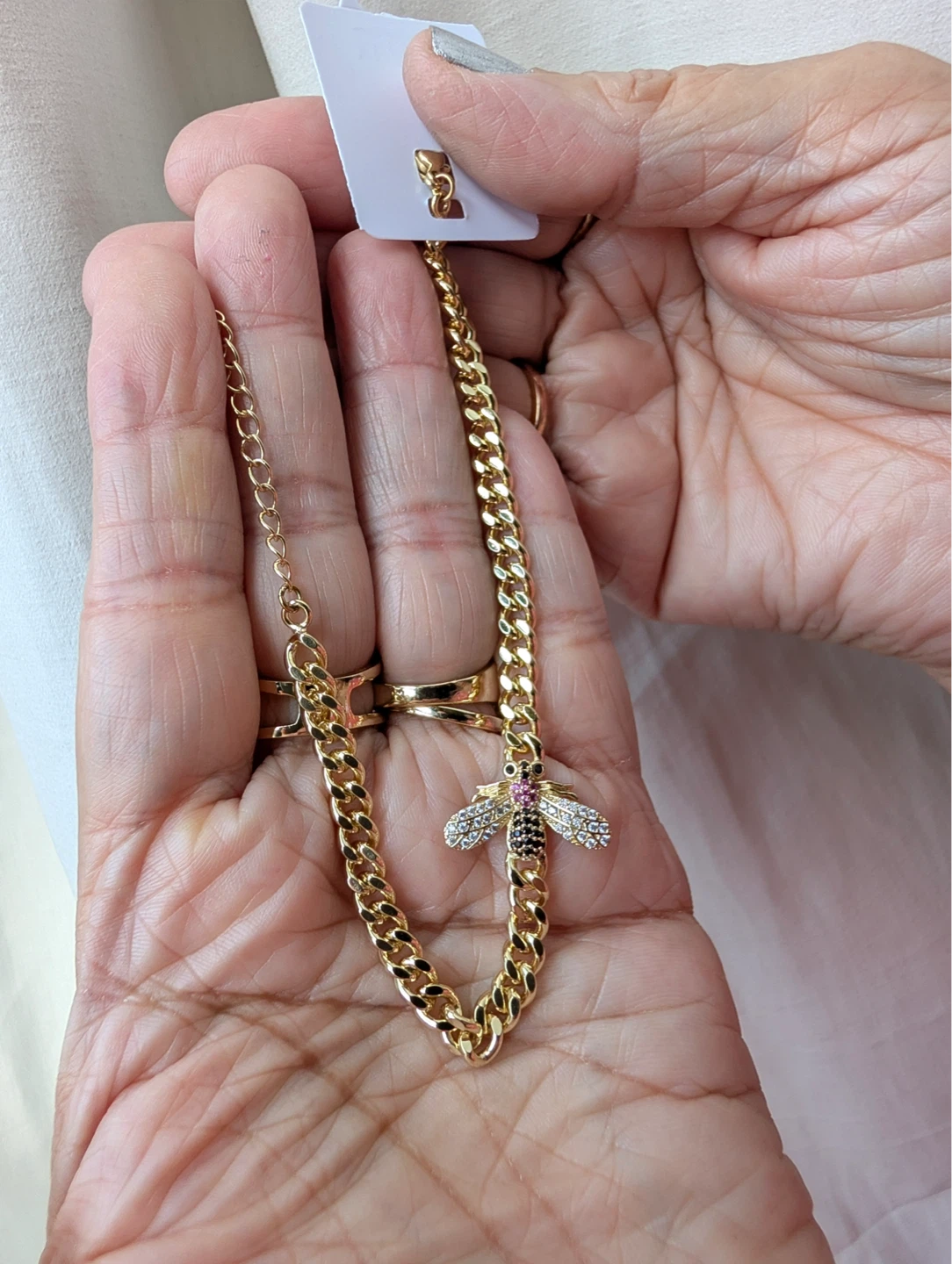 Gold tone necklace with bee pendant