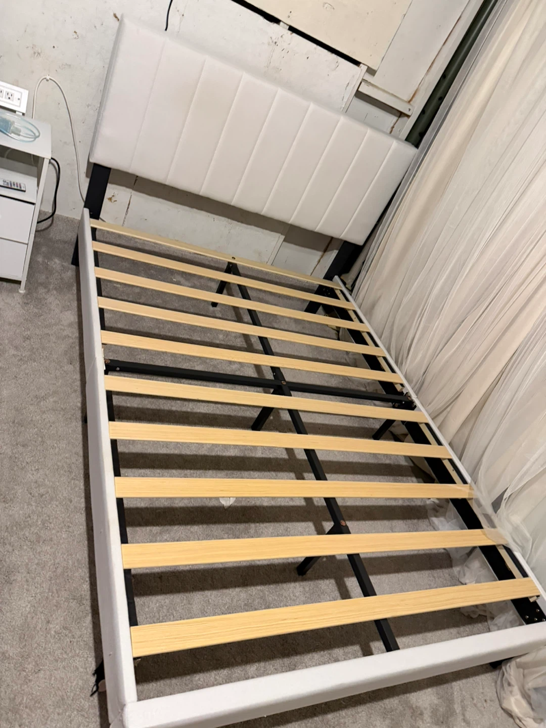 White upholstered bed frame with mattress