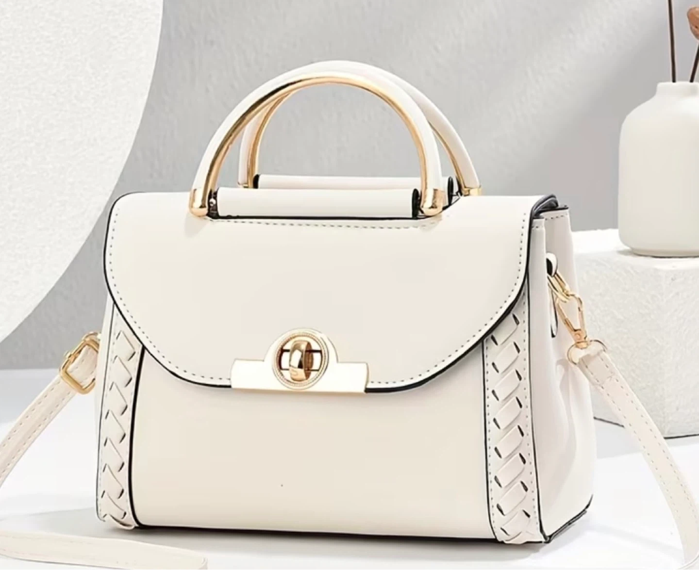 White handbag with gold hardware