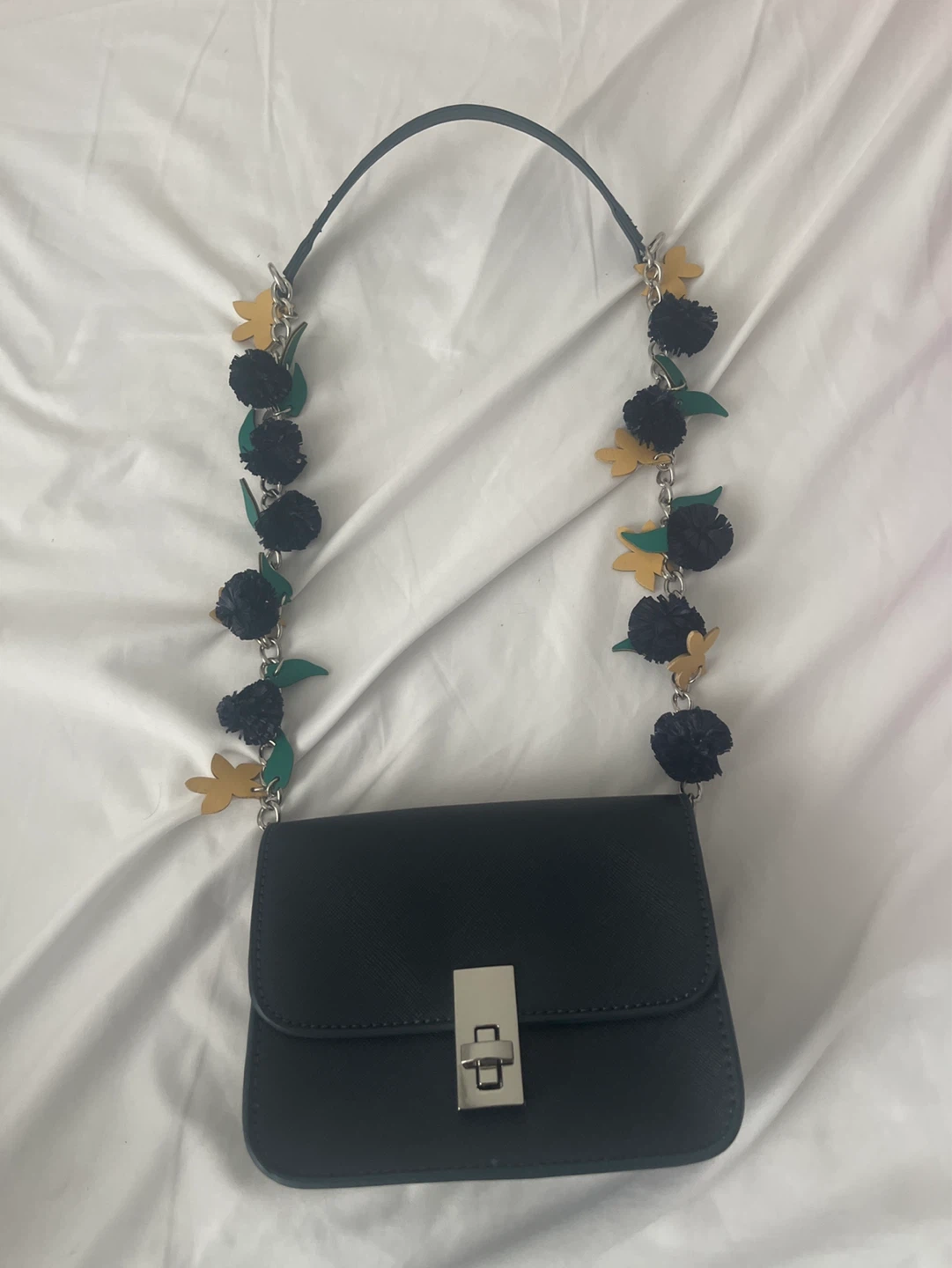 Black shoulder bag with floral chain strap