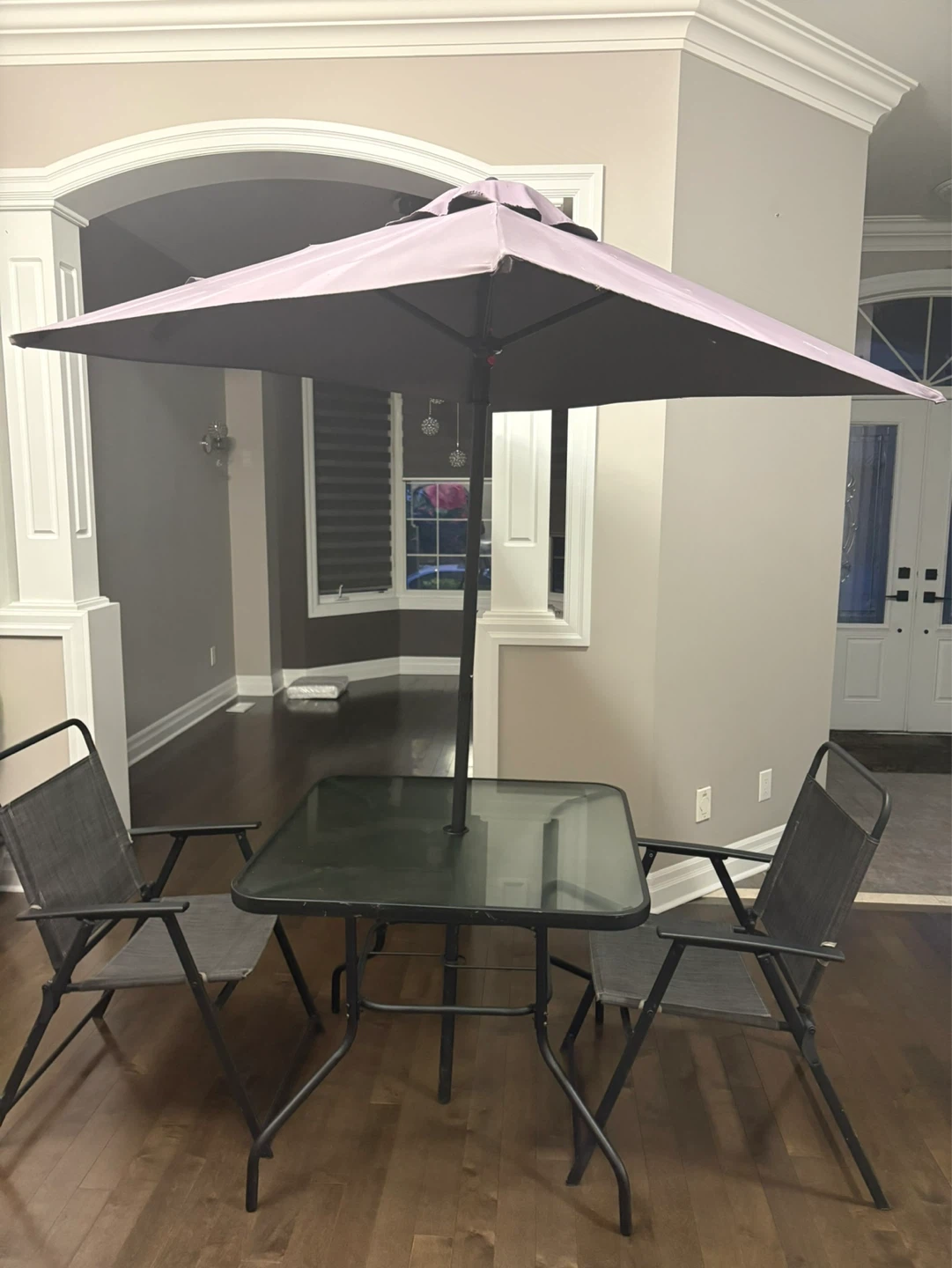 Glass patio table with umbrella and two chairs