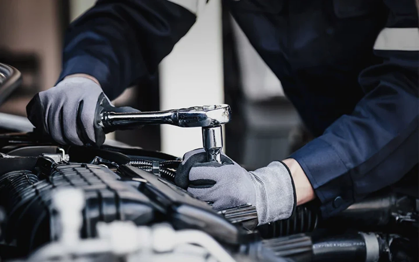 Mechanic working on car engine
