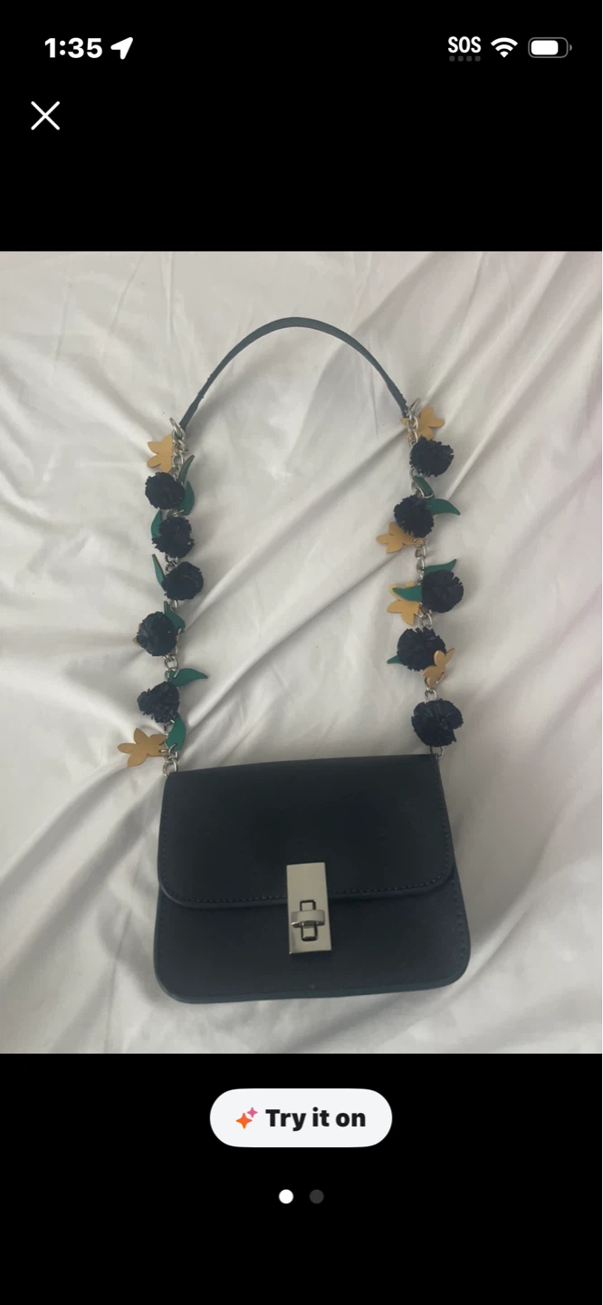 Black crossbody bag with floral chain strap