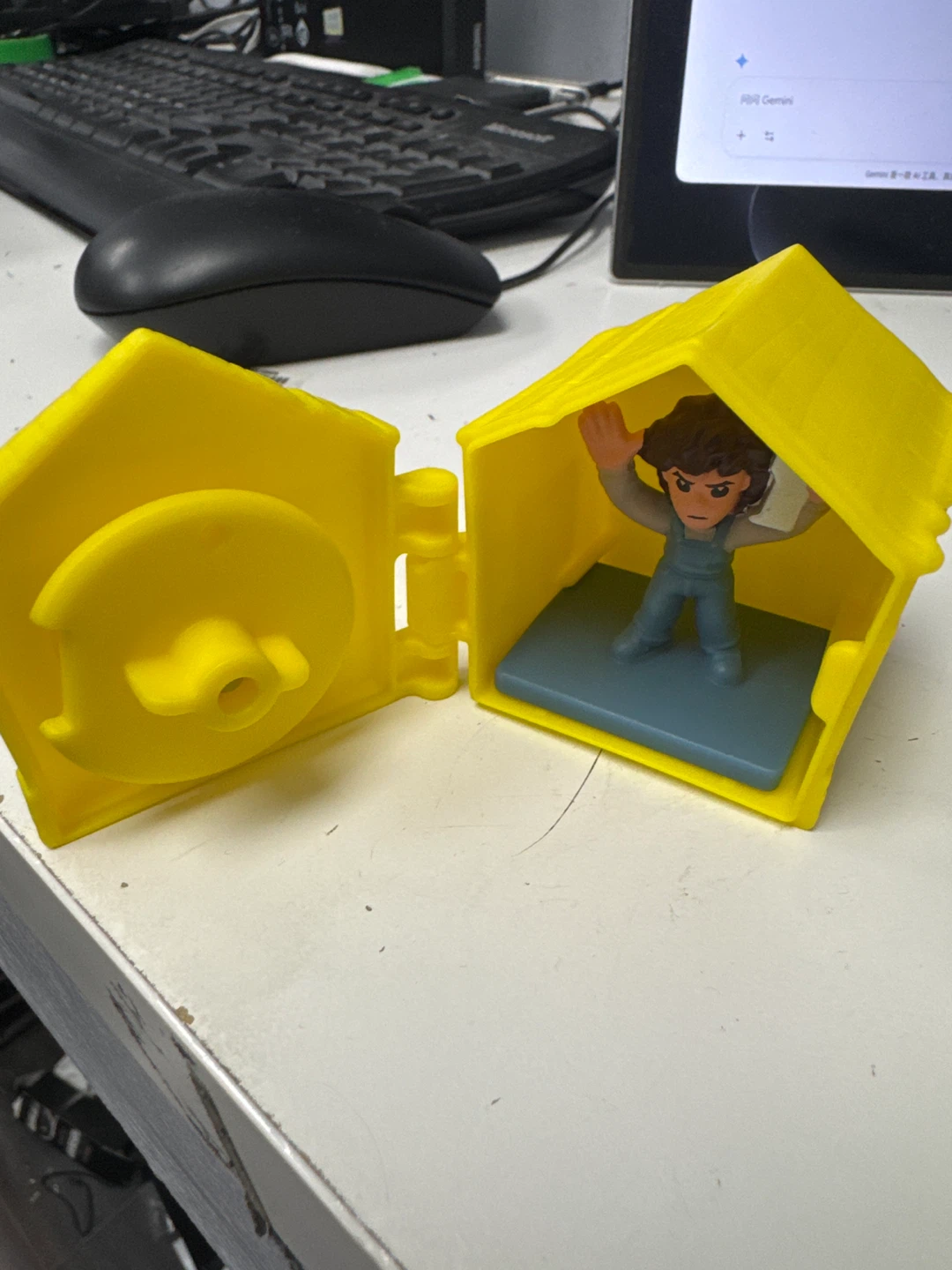 Yellow toy house with figure