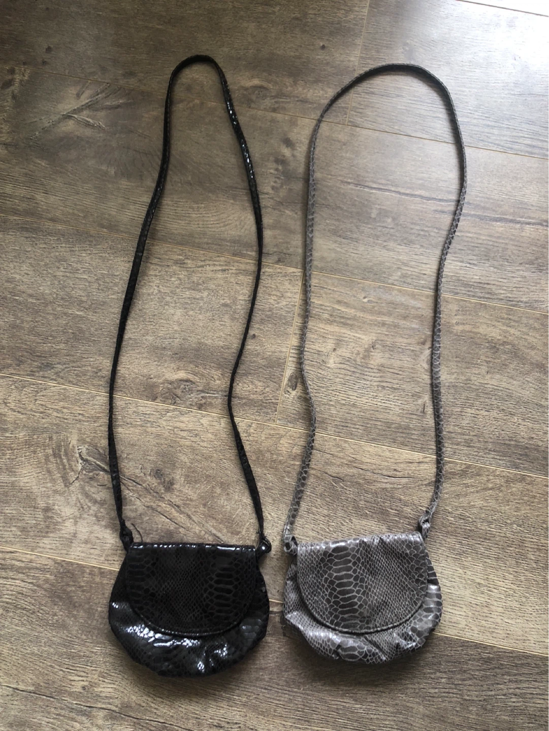 Two small crossbody bags, black and grey snakeskin pattern