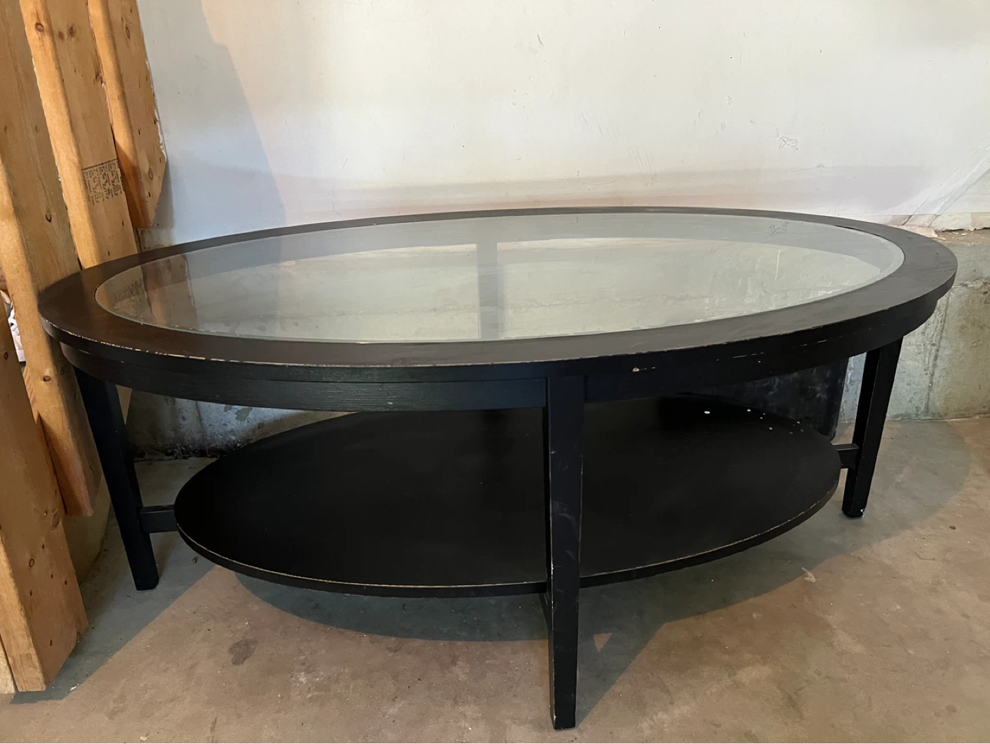 Black Oval Coffee Table with Glass Top and Shelf