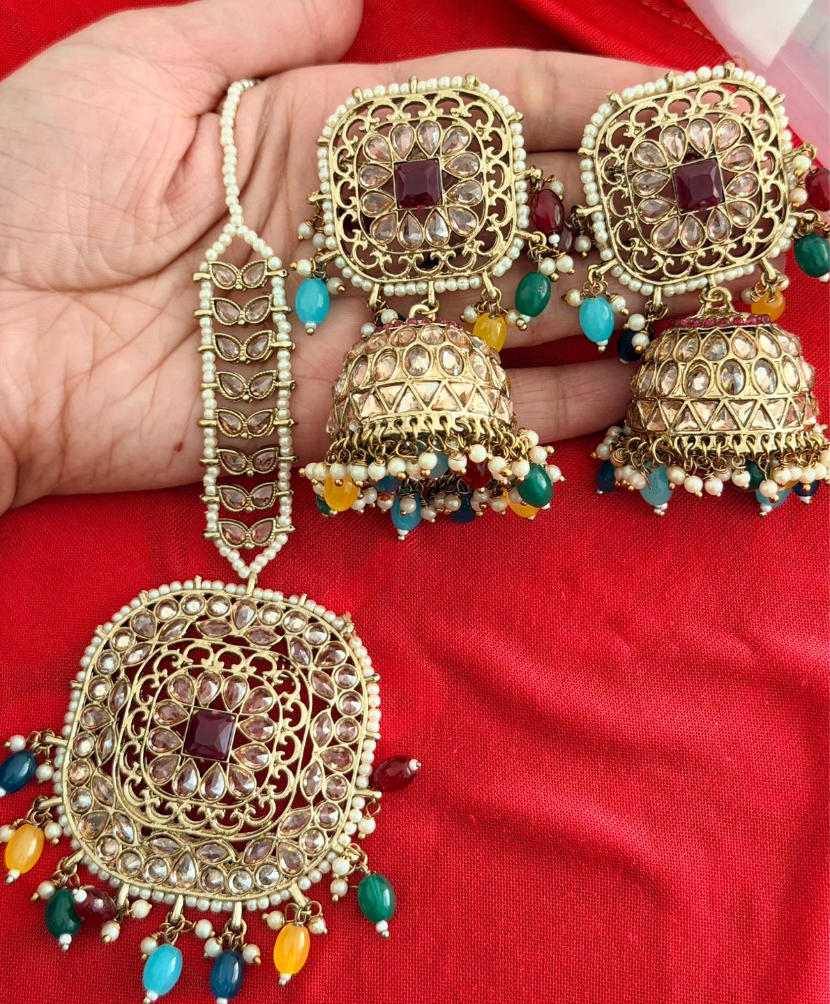Gold Toned Indian Earrings and Tikka Set with Pearls and Stones