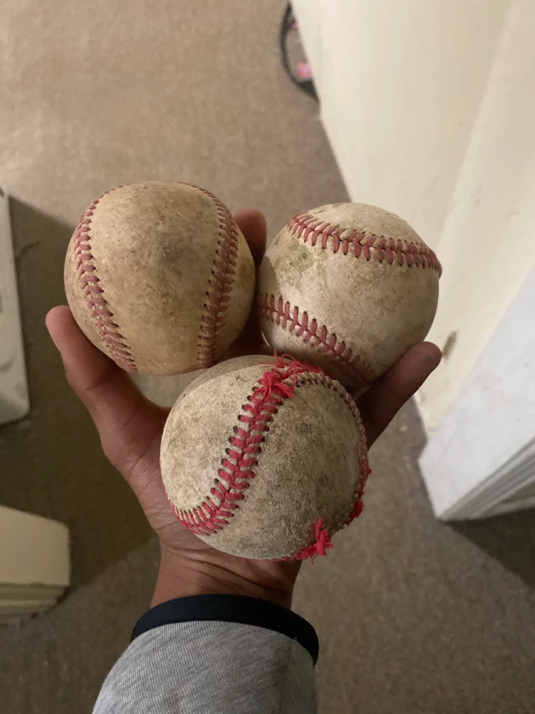 Three used baseballs