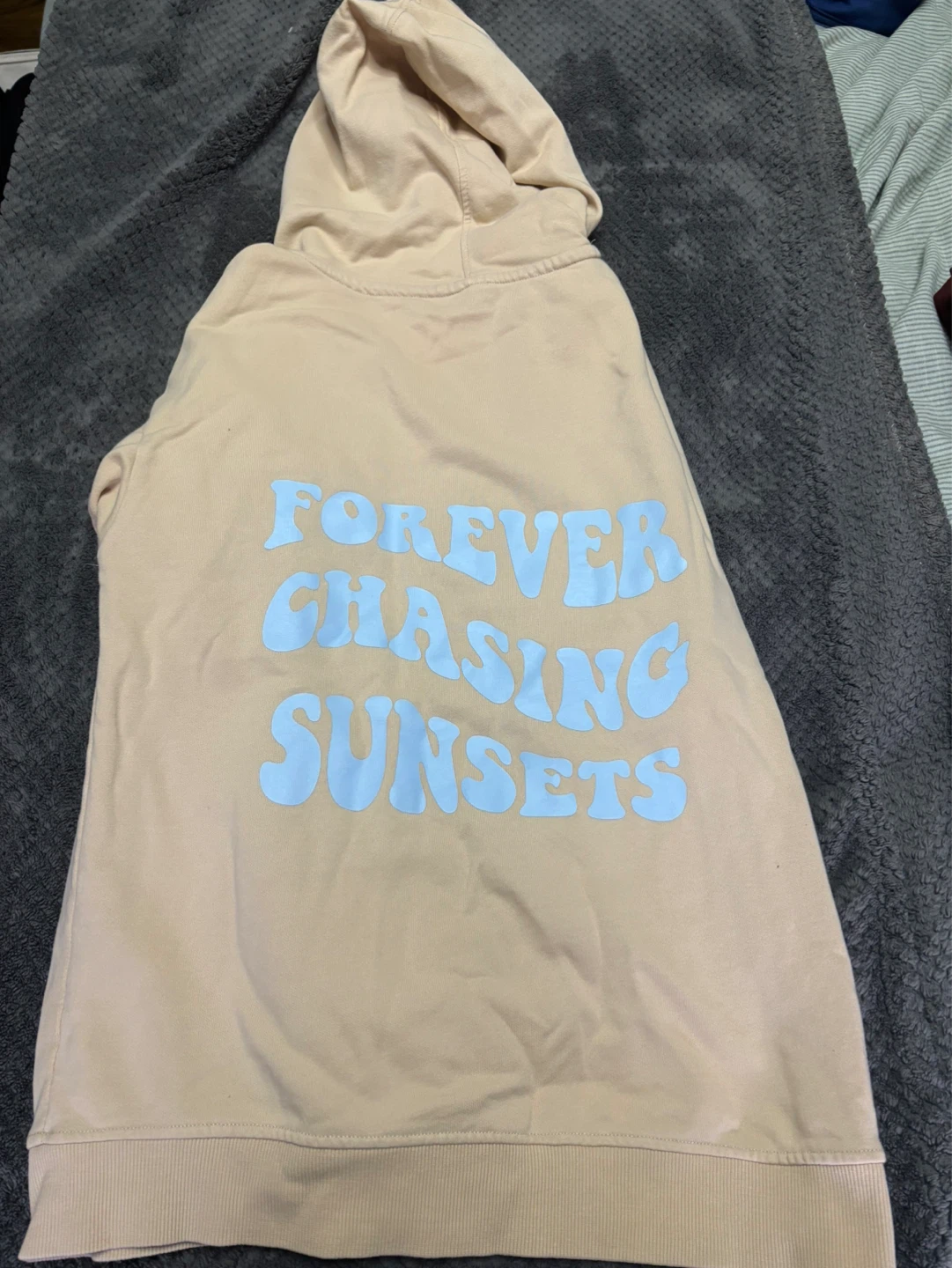 Beige/cream colour hoodie with text on back