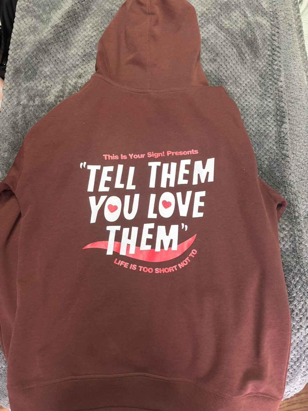 Brown hoodie with text on the back