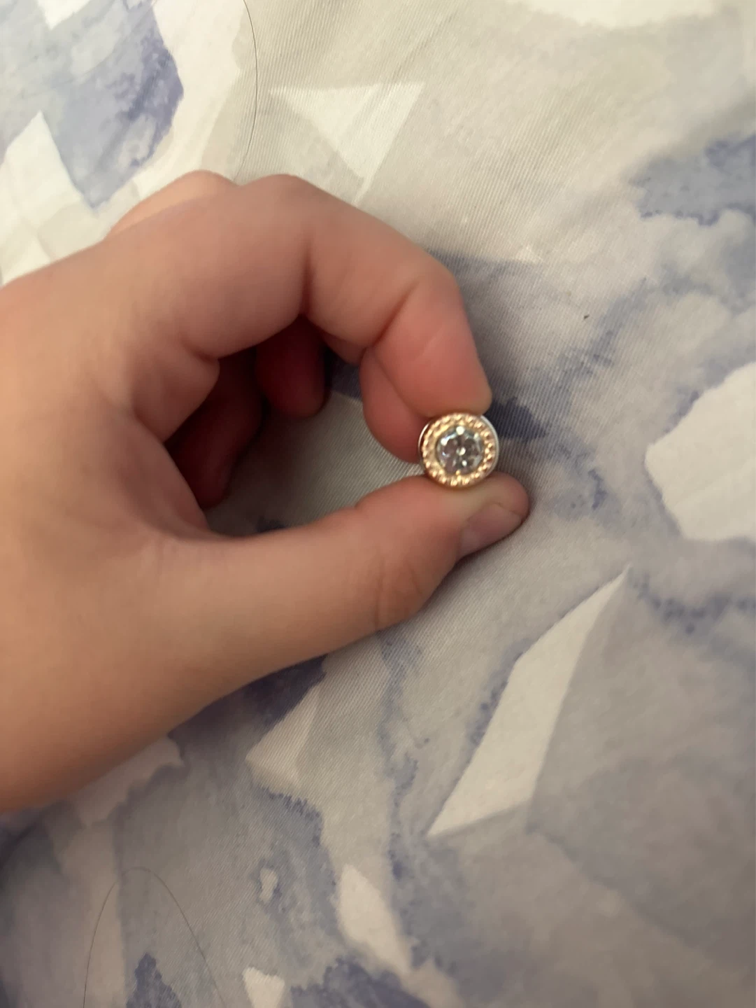 Charm with clear stone and gold trim