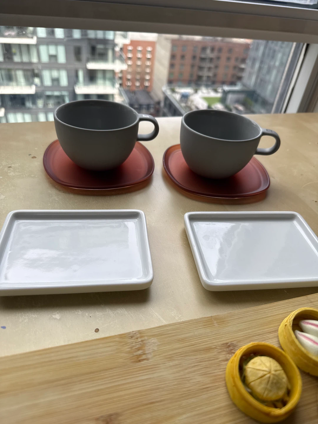 Grey Mugs with Translucent Orange Saucers and White Side Plates