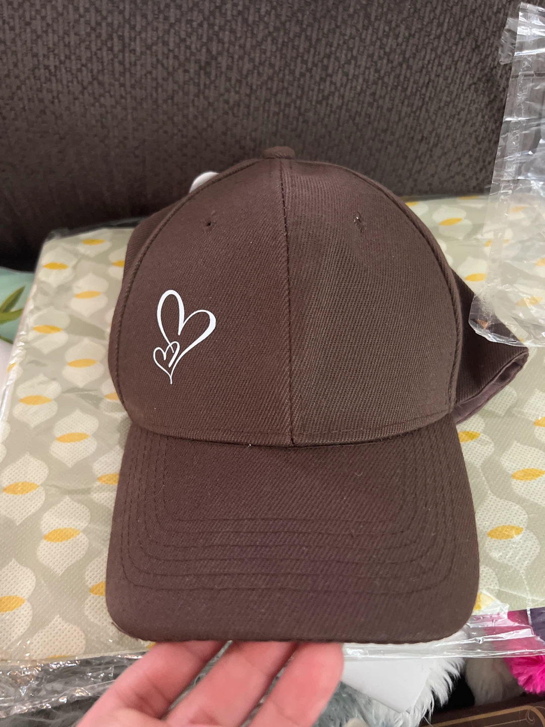 Brown baseball cap with white heart design