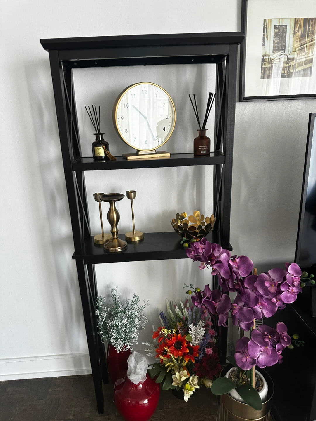 Black leaning shelf with decorative items