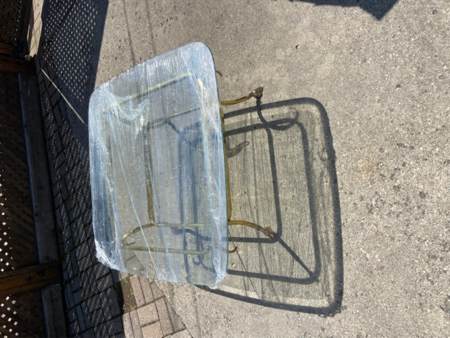 Glass top side table with brass base