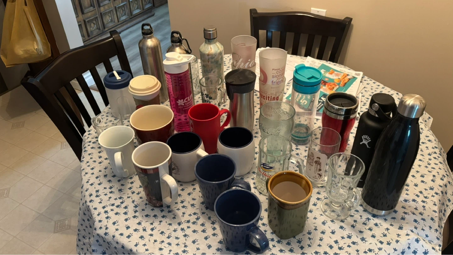 Mixed lot of mugs, travel cups, and water bottles